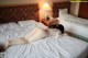 A woman laying on a bed in a hotel room.