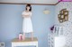 A woman standing on top of a dresser in a room.