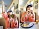 A woman in a bathrobe eating a hamburger and french fries.