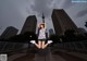 A woman jumping in the air in front of a city skyline.