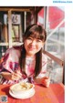 A woman sitting at a table with a bowl of food.