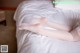 A woman laying on a bed with her legs crossed.